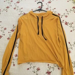 Yellow pullover with a black stripe on the sleeve